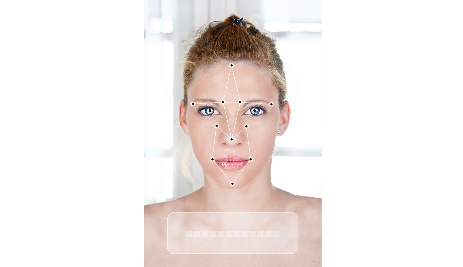 A picture of a woman's face overlaid with a facial recognition pattern.