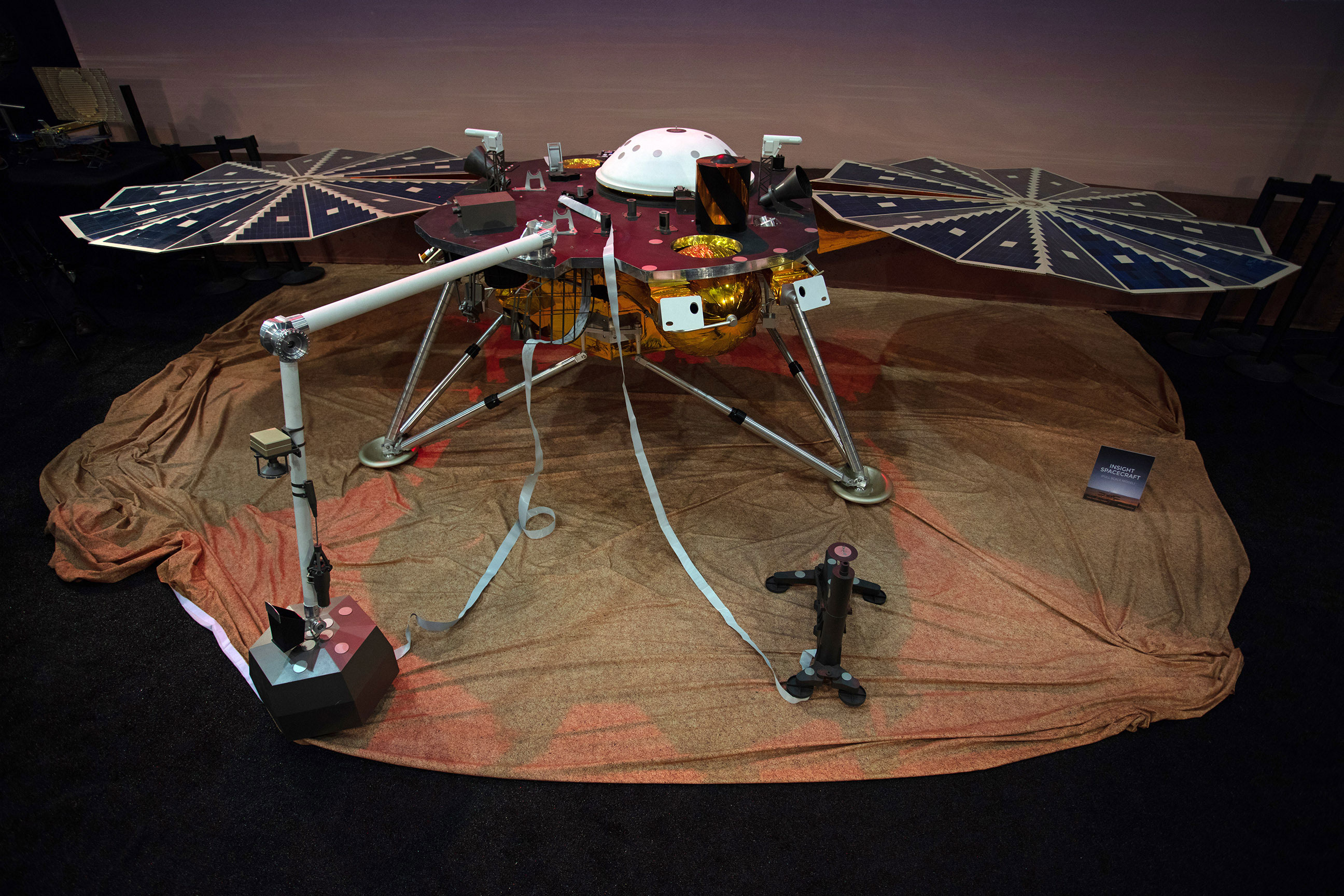 With deployed solar arrays, InSight is 19 feet wide (6 meters), just over 3 feet tall (~1 meter), and weighs only 790 pounds (358 kilograms).  This is a full-scale model of lander.  Photo: Jon Brack