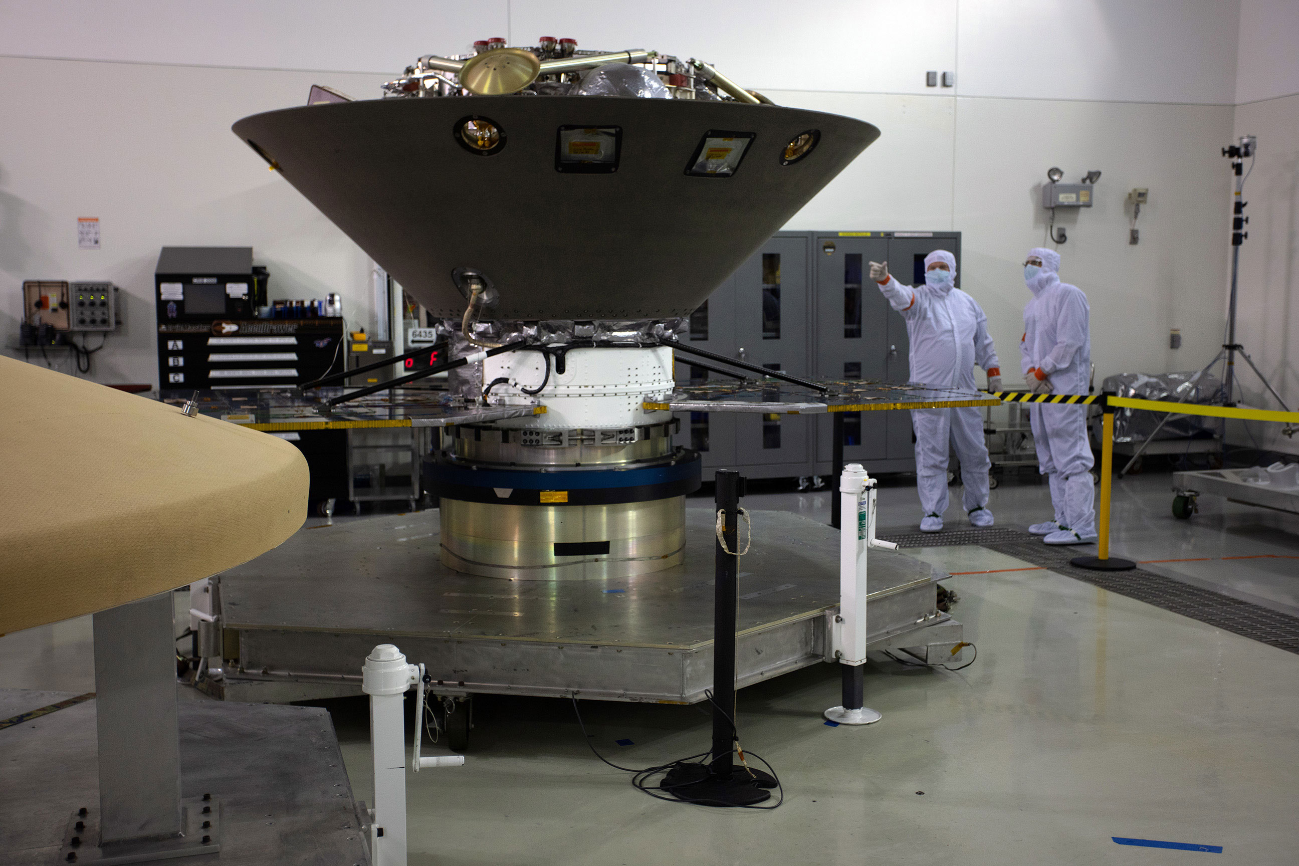 InSight in the Astrotech cleanroom at Vandenberg Air Force Base in final preparations for launch.  Only part of the lander’s legs are visible above the aeroshell capsule that will protect it on the 6-month journey to Mars.  Photo: Jon Brack