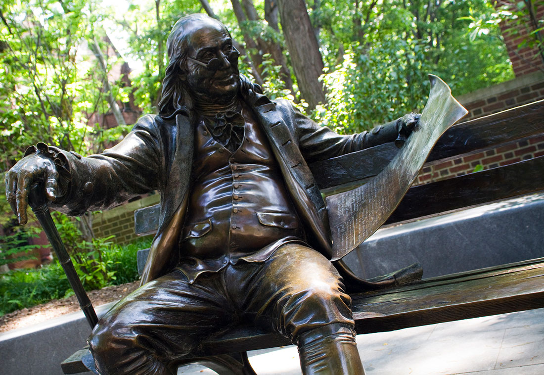 Sculpture of Benjamin Franklin on a bench at The University of Pennsylvania