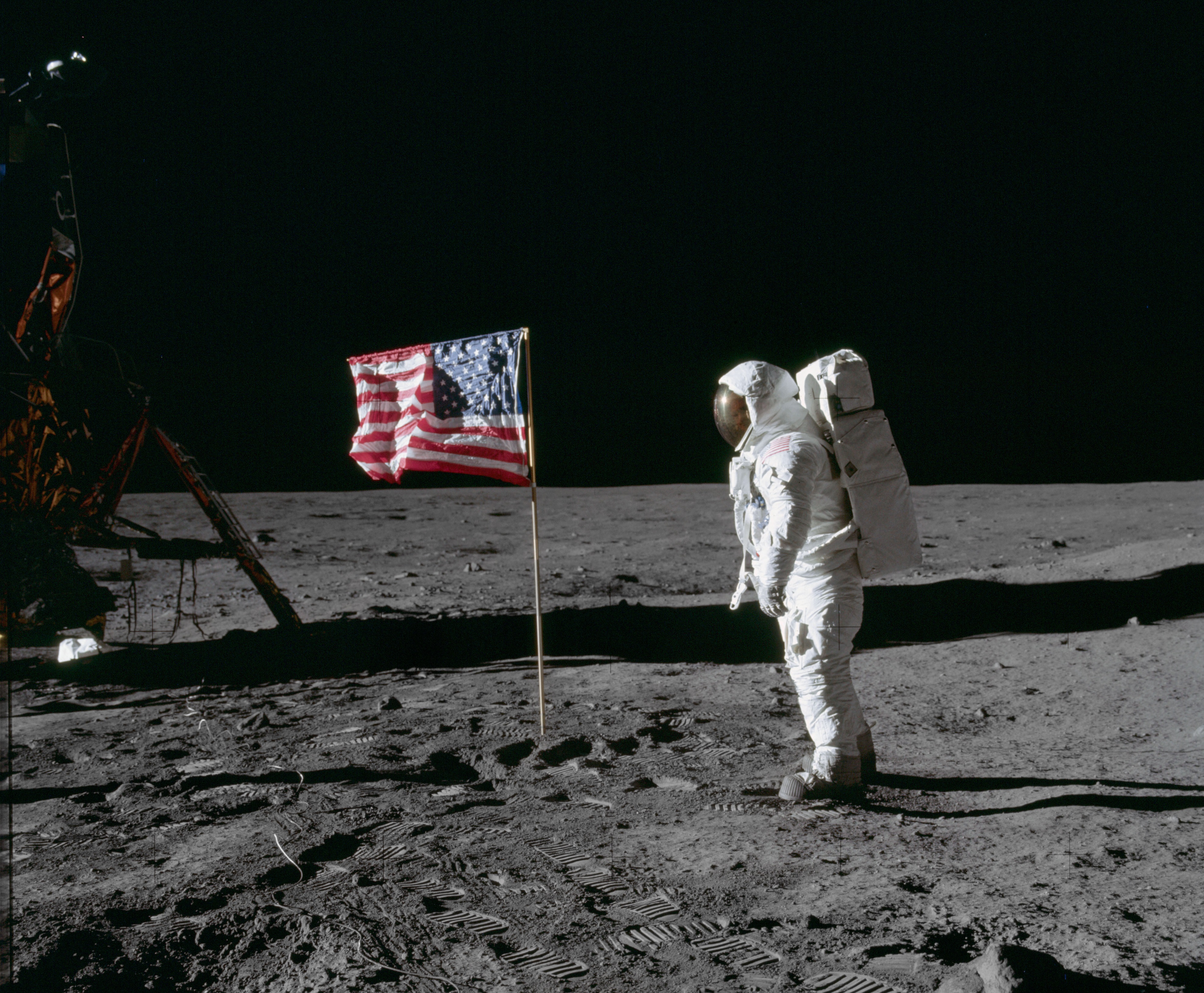 astronaut on moon with American Flag