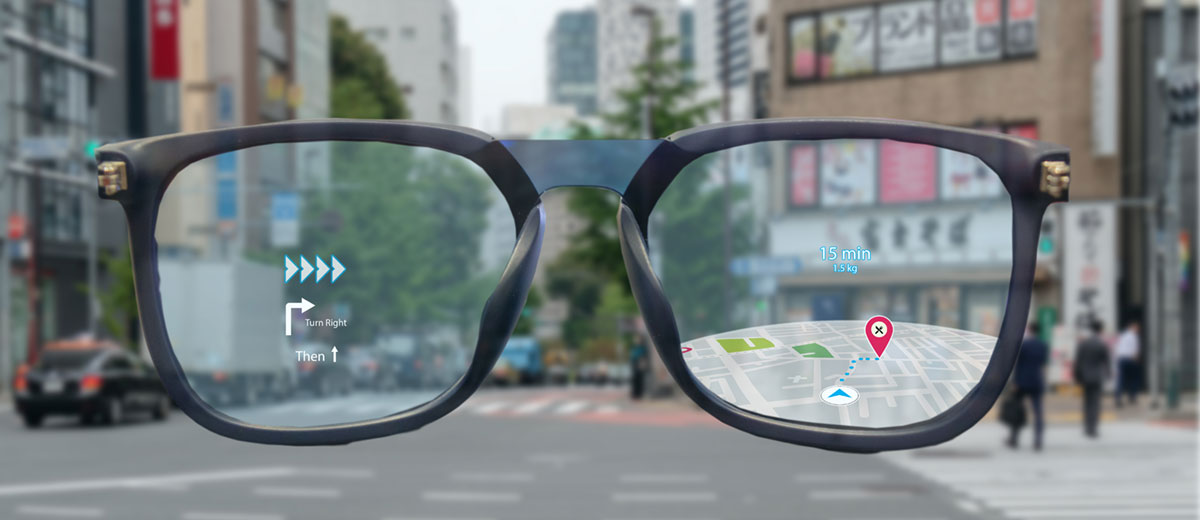 Looking through a pair of black-framed eyeglasses, we see an illustration of a map with walking directions overlaid on a photograph of a real city street.