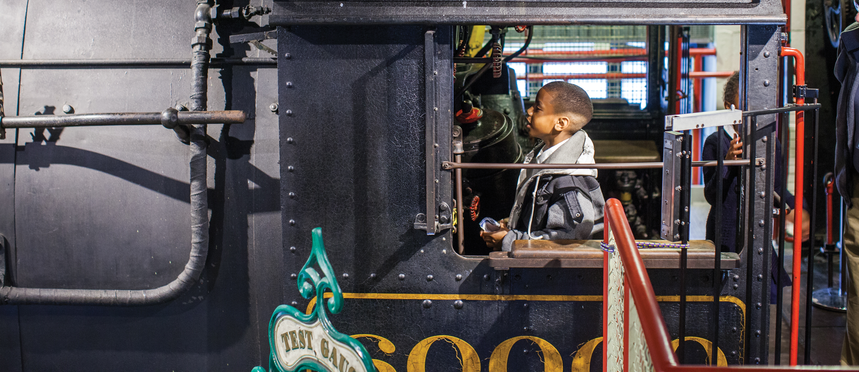 Young boy intrigued by the Baldwin 60,000 in Train Factory.