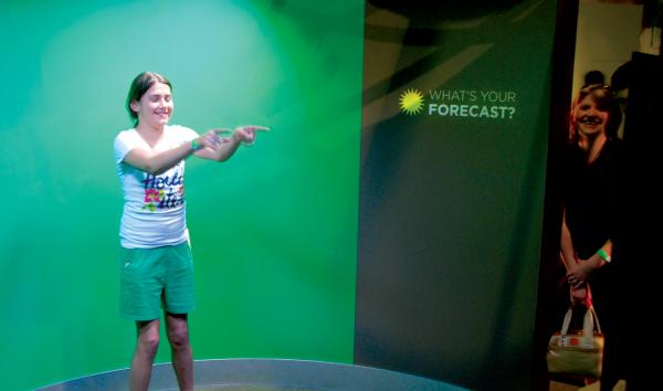 Teenage girl recording her own weather forcast in Changing Earth at The Franklin Institute.
