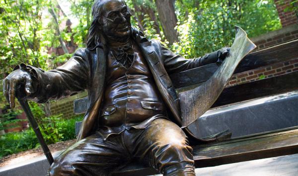 Sculpture of Benjamin Franklin on a bench at The University of Pennsylvania