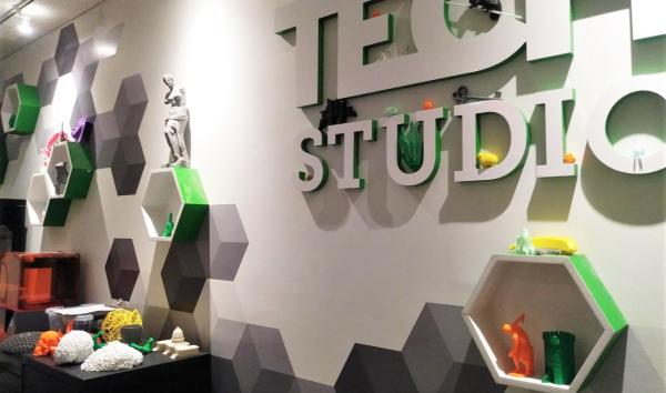 A wall at The Franklin Institute is decorated with hexagons and 3D printed objects and bears the label, "Tech Studio."