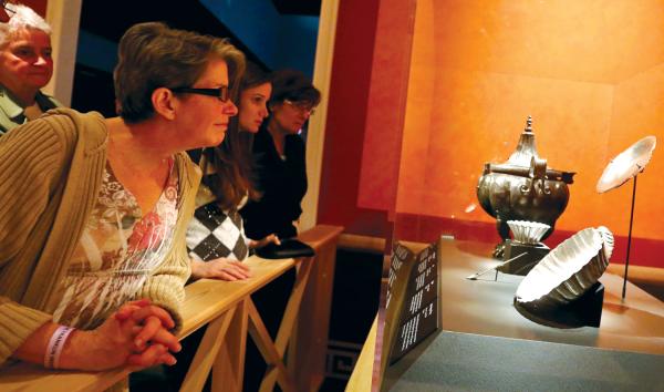 Educators looking at a collection of artifacts at the Franklin Institute.