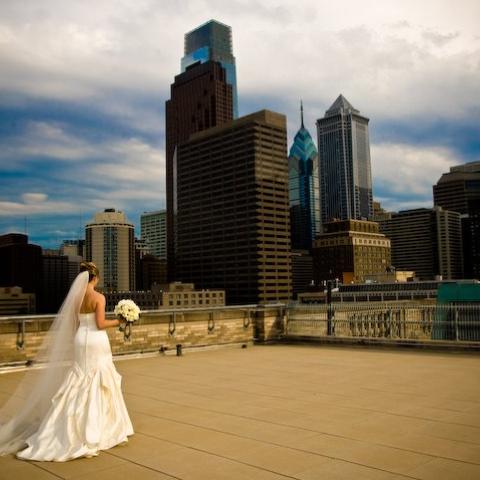 A bride walking across the rooftop deck of The Franklin Institute.