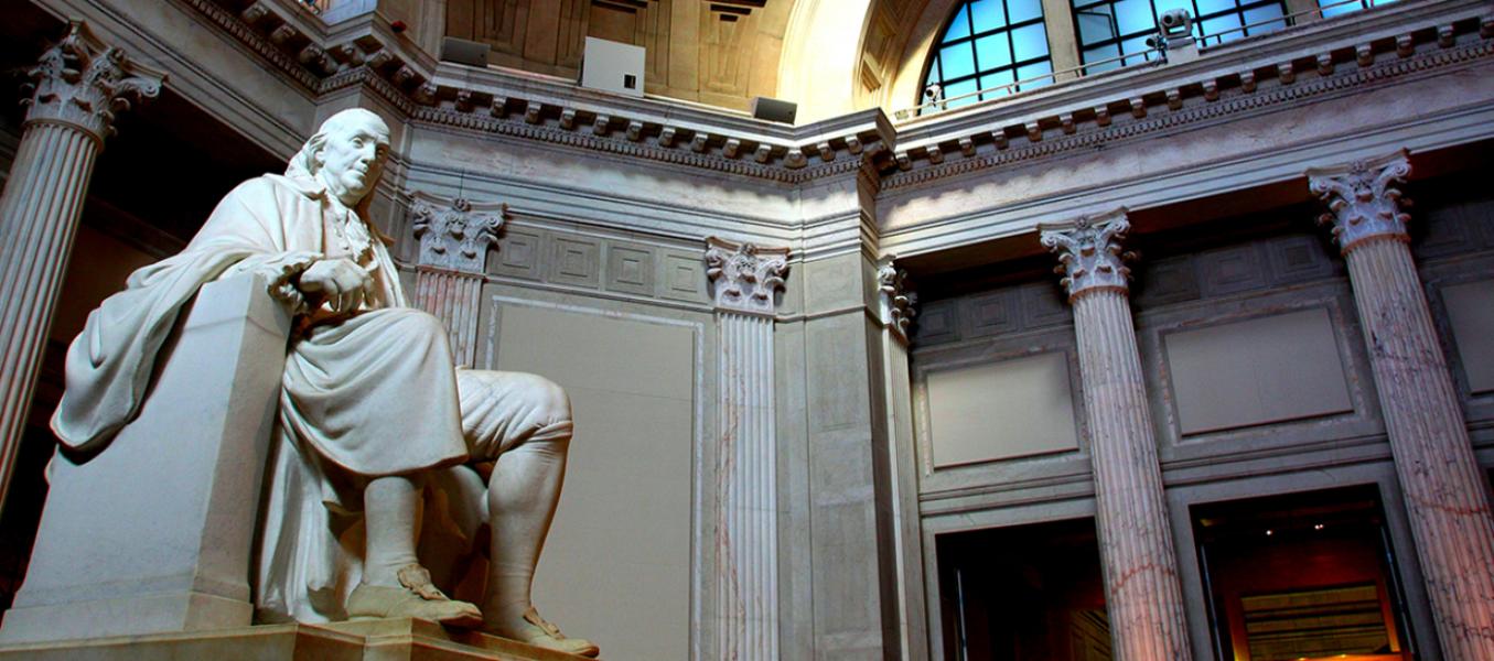 Photograph of the inside of Franklin Hall, showing part of the large marble statue of Benjamin Franklin.